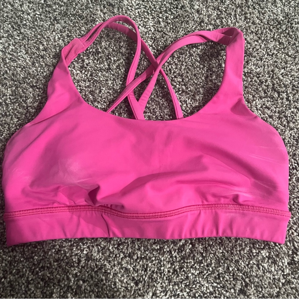 Pink Lululemon Sports Bra with Crossed Straps and Moisture-Wicking Fabric